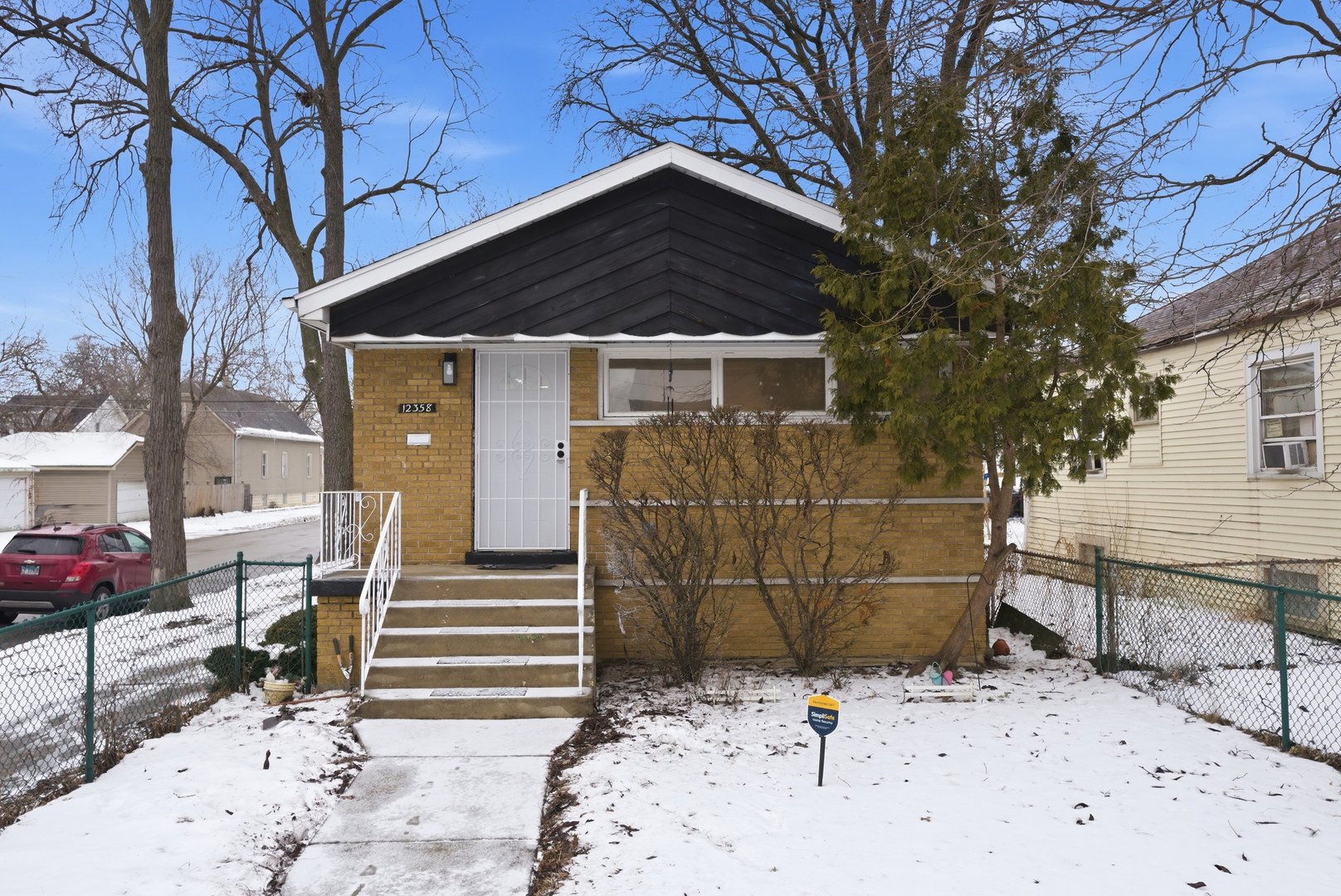 12358 South Lowe Avenue Chicago, IL 60628 - Photo 2 of 14 a front view of a house with parking