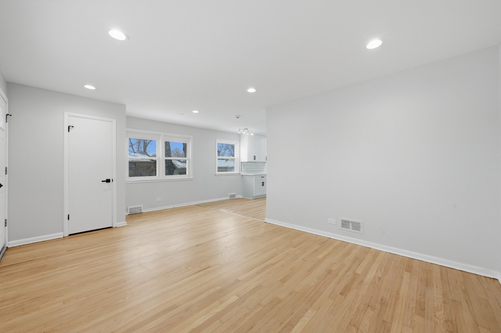 12358 South Lowe Avenue Chicago, IL 60628 - Photo 3 of 14 an empty room with wooden floor and windows