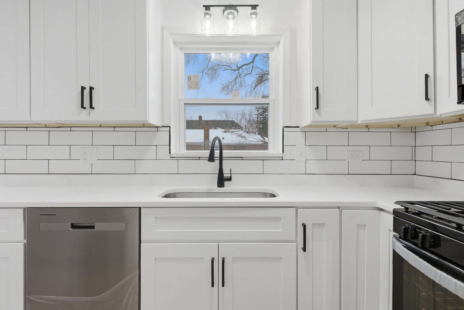 12358 South Lowe Avenue Chicago, IL 60628 - Photo 5 of 14 a kitchen with white cabinets and a stove