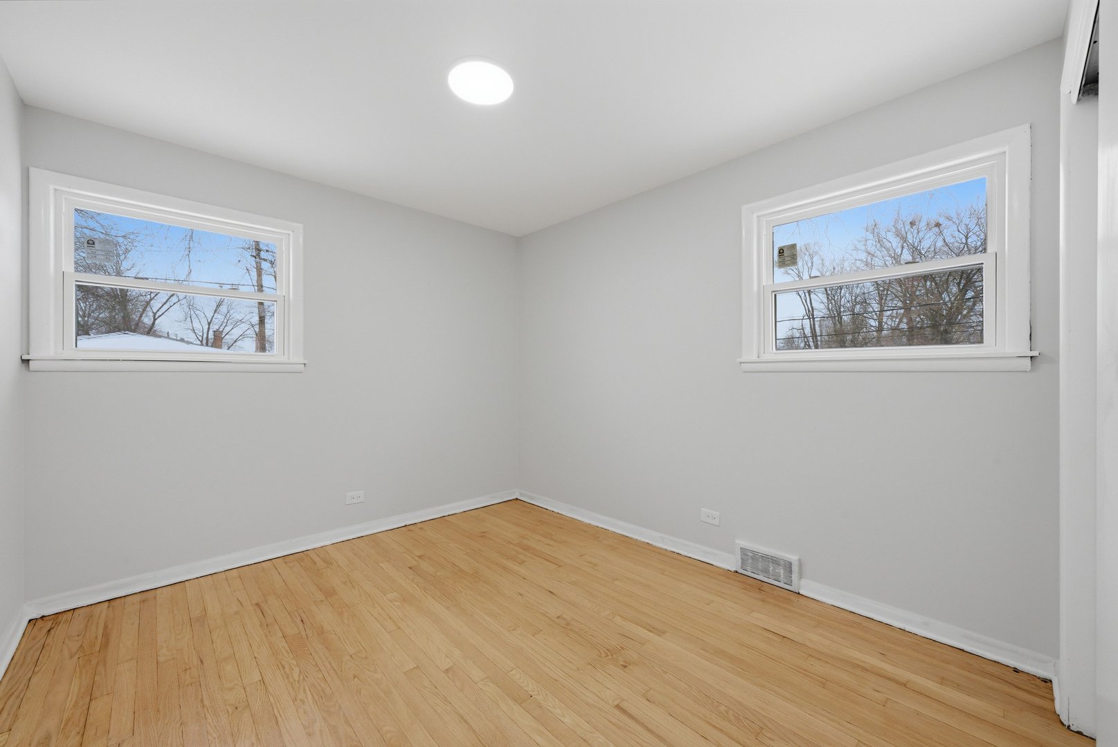 12358 South Lowe Avenue Chicago, IL 60628 - Photo 6 of 14 a view of an empty room with wooden floor