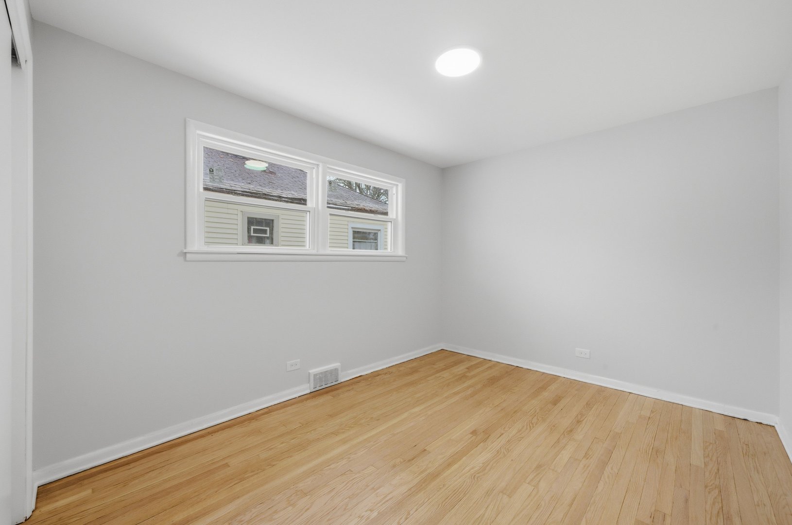 12358 South Lowe Avenue Chicago, IL 60628 - Photo 7 of 14 a view of empty room with wooden floor and fan