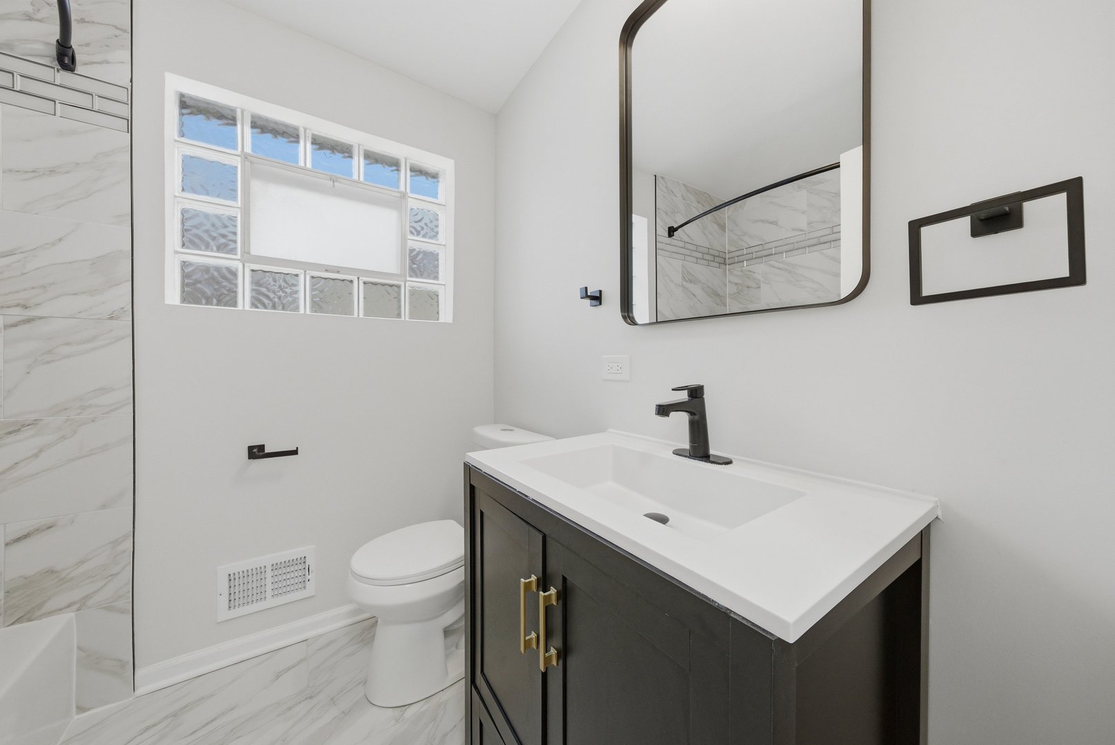 12358 South Lowe Avenue Chicago, IL 60628 - Photo 8 of 14 a bathroom with a sink mirror and toilet