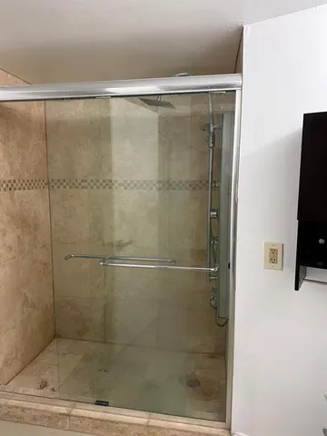 a bathroom with a glass shower door