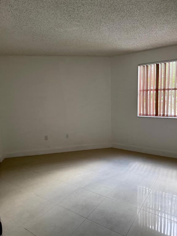 6276 Northwest 186th Street, Unit 310 Hialeah, FL 33015 - Photo 13 of 21 an empty room with a window