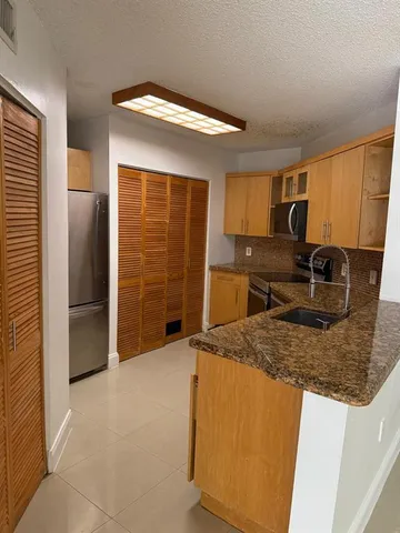 a stove top oven sitting inside of a kitchen