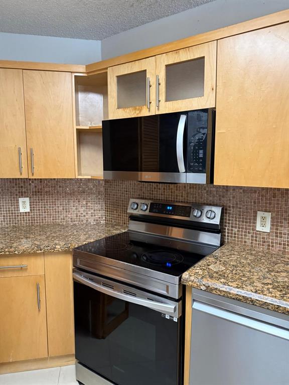 6276 Northwest 186th Street, Unit 310 Hialeah, FL 33015 - Photo 16 of 21 a stove top oven sitting inside of a kitchen