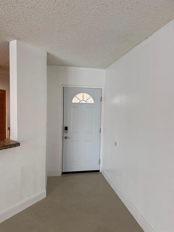 6276 Northwest 186th Street, Unit 310 Hialeah, FL 33015 - Photo 18 of 21 an empty room with windows