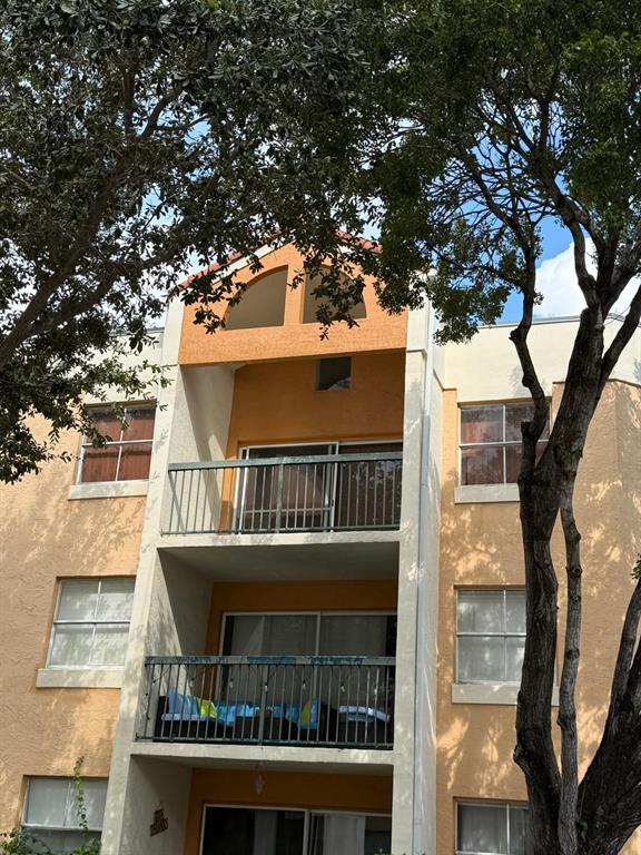 6276 Northwest 186th Street, Unit 310 Hialeah, FL 33015 - Photo 20 of 21 a balcony view with a large garden space