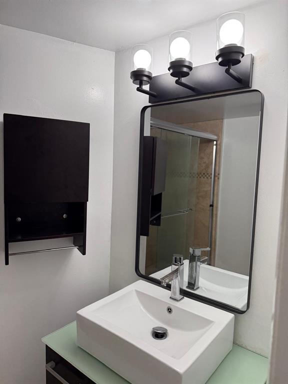 6276 Northwest 186th Street, Unit 310 Hialeah, FL 33015 - Photo 10 of 21 a bathroom with a sink and a mirror