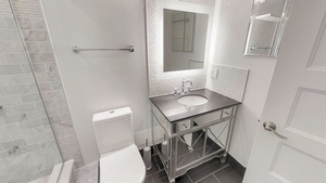 1069 West 14th Place, Unit 123 Chicago, IL 60608 - Photo 14 of 20 a bathroom with a sink and mirror