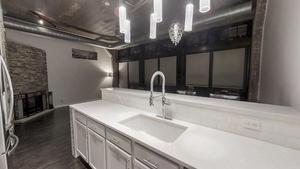 1069 West 14th Place, Unit 123 Chicago, IL 60608 - Photo 7 of 20 a kitchen with a sink and a refrigerator