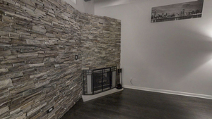 1069 West 14th Place, Unit 123 Chicago, IL 60608 - Photo 9 of 20 a room with a wooden floor and a fireplace