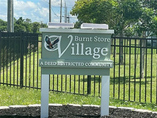 a view of outdoor space with a garden and signage