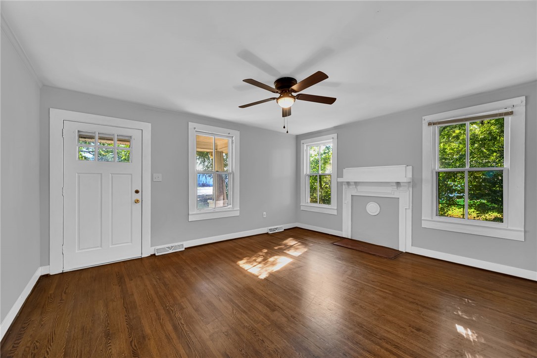 403 Lewis Street Anderson, SC 29624 - Photo 5 of 35 Rich hardwood floors and a decorative fireplace anchor this welcoming living area.