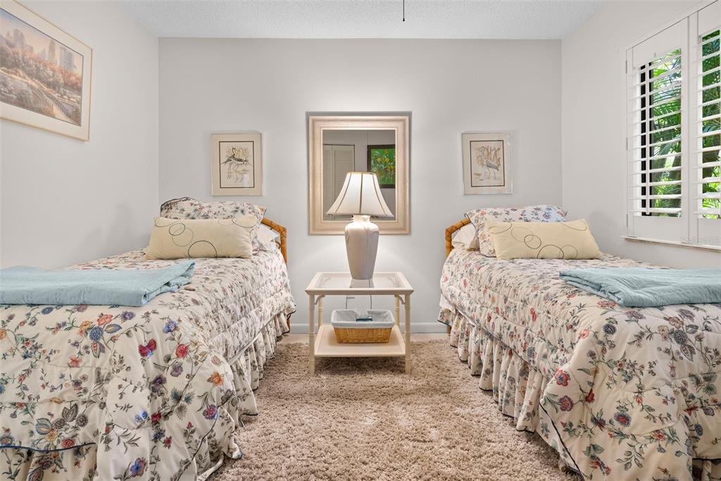 1703 Pelican Cove Road, Unit 356 Sarasota, FL 34231 - Photo 16 of 51 a bedroom with a bed and wooden floor