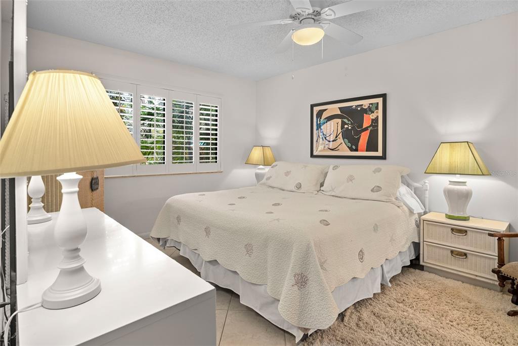 1703 Pelican Cove Road, Unit 356 Sarasota, FL 34231 - Photo 20 of 51 a bedroom with a bed and a lamp