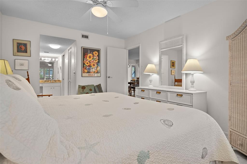 1703 Pelican Cove Road, Unit 356 Sarasota, FL 34231 - Photo 21 of 51 a view of a bedroom with furniture and lamp