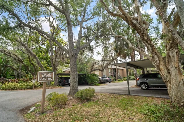 a front view of a house with a yard and car parked