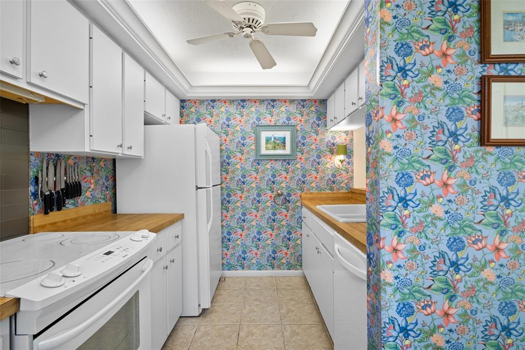 1703 Pelican Cove Road, Unit 356 Sarasota, FL 34231 - Photo 9 of 51 a kitchen with stainless steel appliances granite countertop a refrigerator and a sink