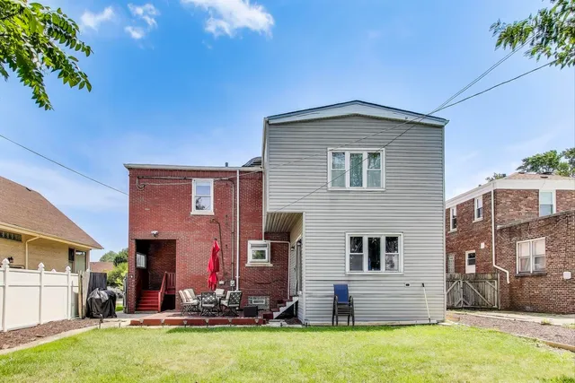 a front view of house with yard and outdoor seating