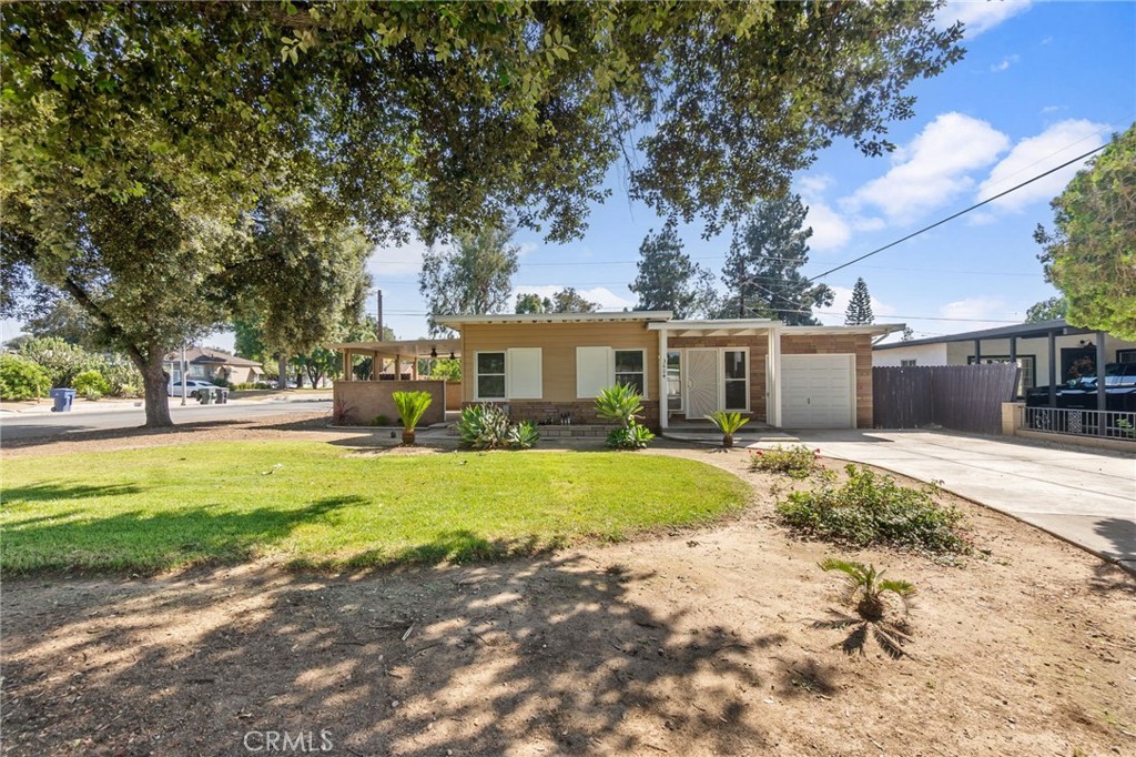 3604 Cortez Street Riverside, CA 92504 - Photo 1 of 1 a front view of a house with a yard and trees