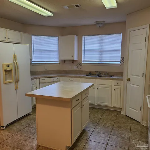 a kitchen with a sink stove and refrigerator