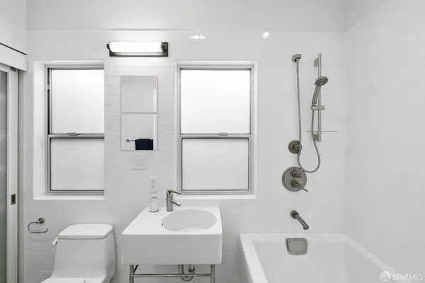 a bathroom with a bathtub and a shower