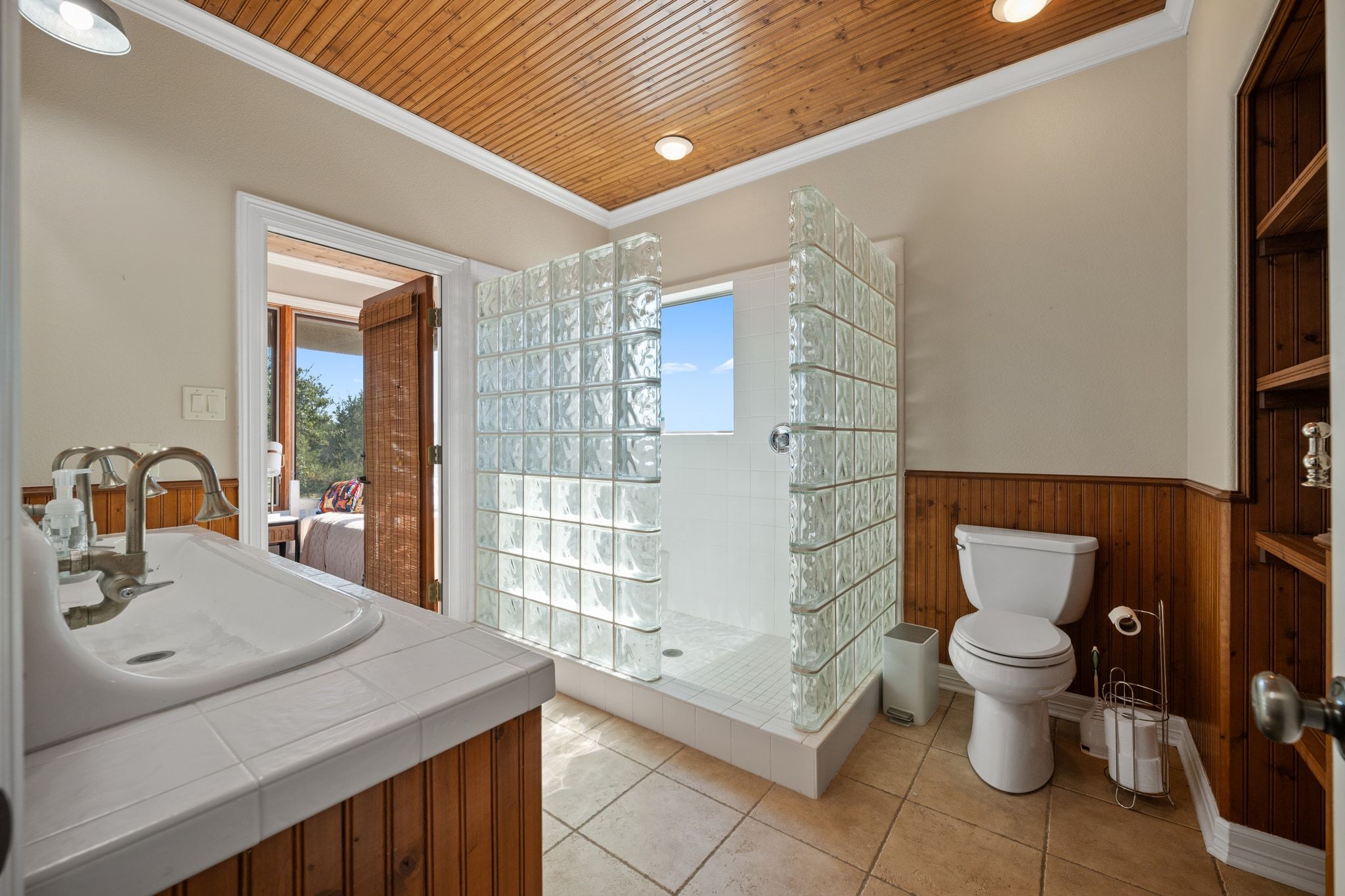 185 Shimmering Shore Court Spring Branch, TX 78070 - Photo 23 of 36 Bathroom with vanity, crown molding, a wainscoted wall, light tile patterned flooring, and a shower stall
