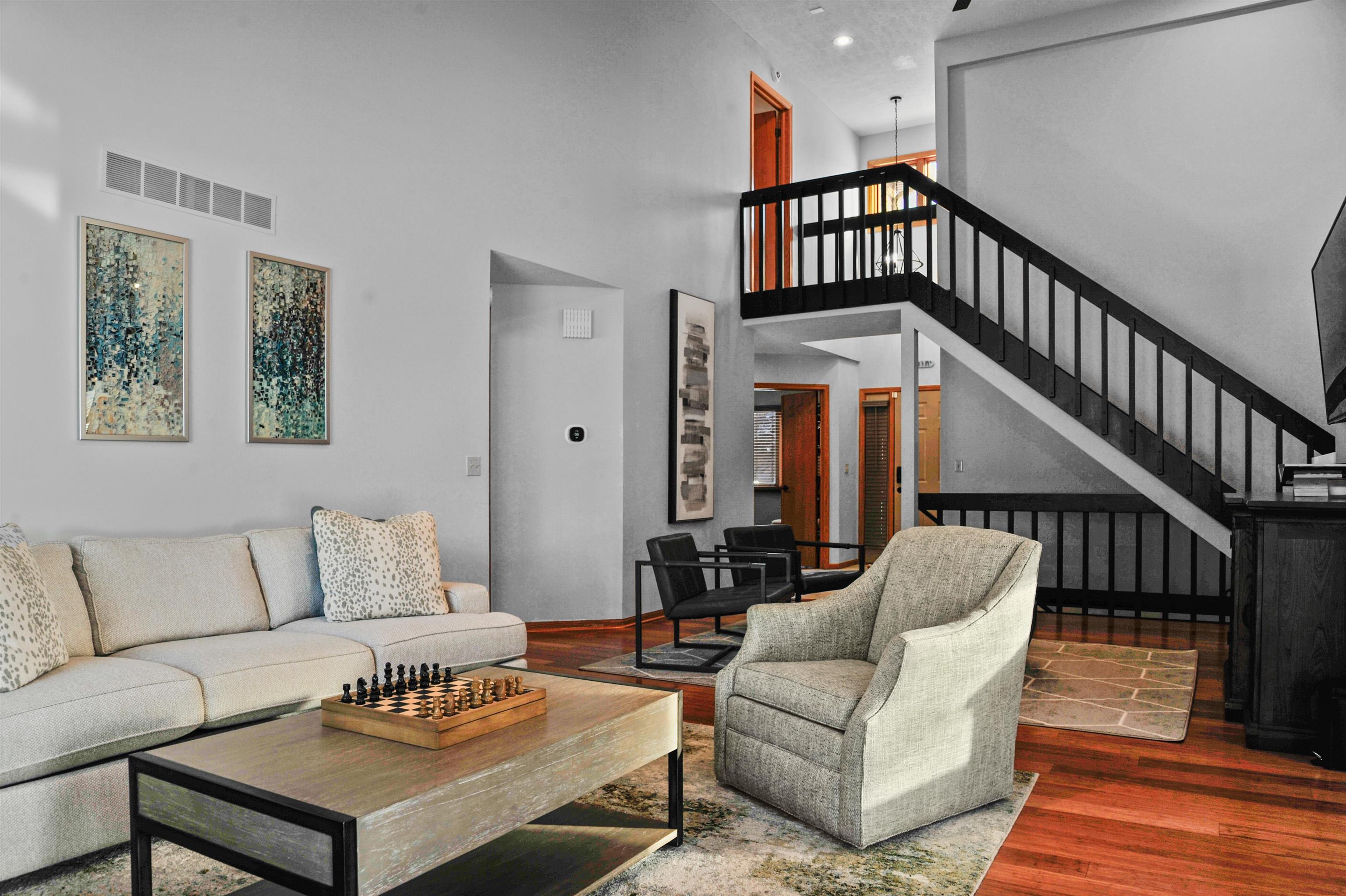6442 Old Hunters Run Rockford, IL 61114 - Photo 7 of 38 a living room with furniture stairs and a wooden floor