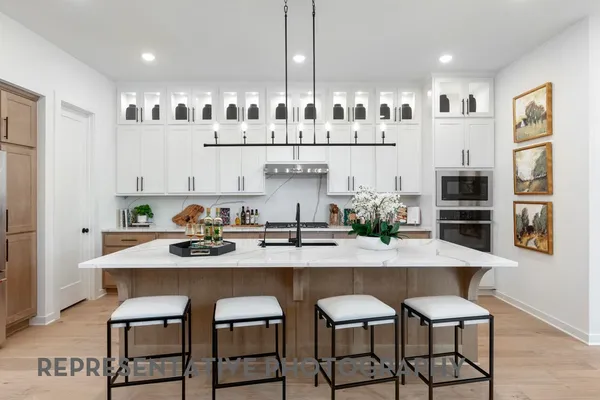 a kitchen with granite countertop white cabinets and stainless steel appliances