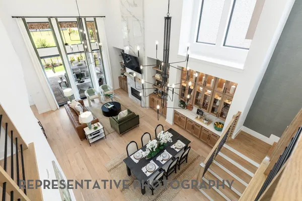 a living room with furniture and a floor to ceiling window