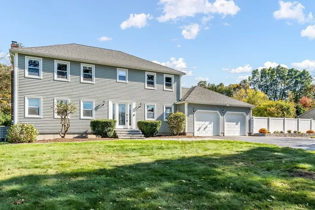 a front view of house with yard and green space