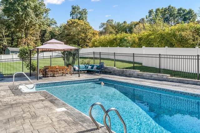 a backyard view with a seating space