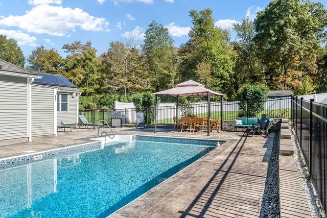 a view of a house with backyard and sitting area