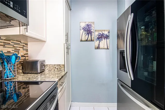 a kitchen with a refrigerator and a stove