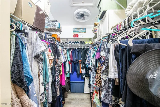 a view of walk in closet with clothes