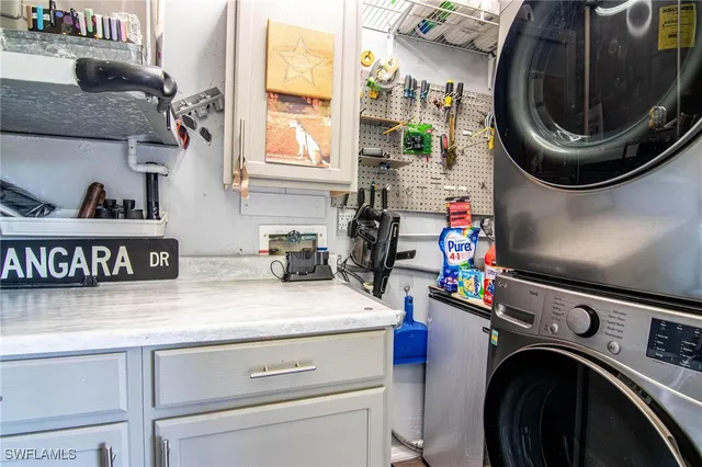 a utility room with sink dryer and washer