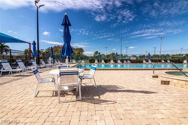 a swimming pool with outdoor seating