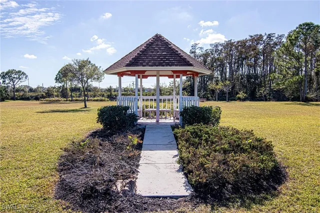 a front view of house with yard and ocean view