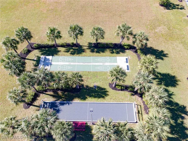 an aerial view of a house with a yard and lake view