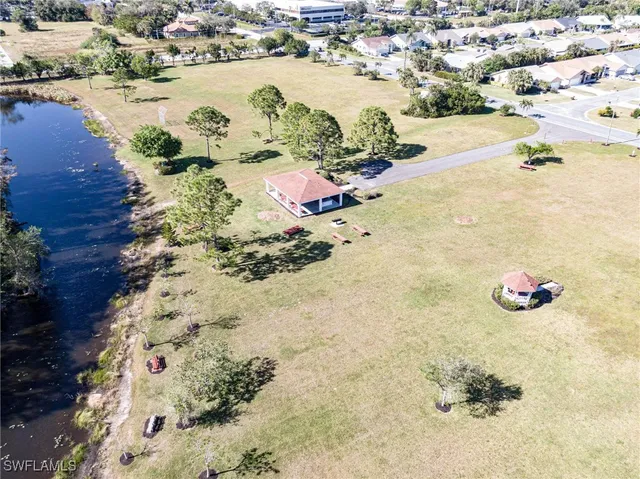 an aerial view of a house with a yard and lake view