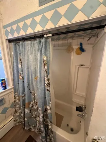 a bathroom with a shower and a tub
