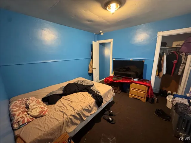 a bedroom with two beds and painted walls