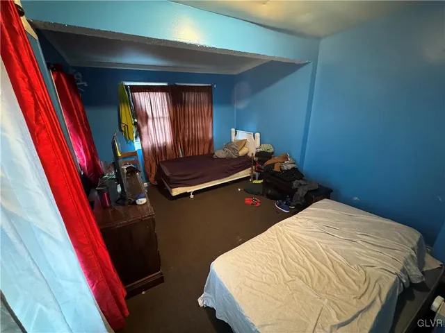 a bed room with a bed and a window