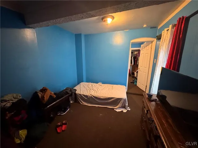 a bed sitting in a room next to a window