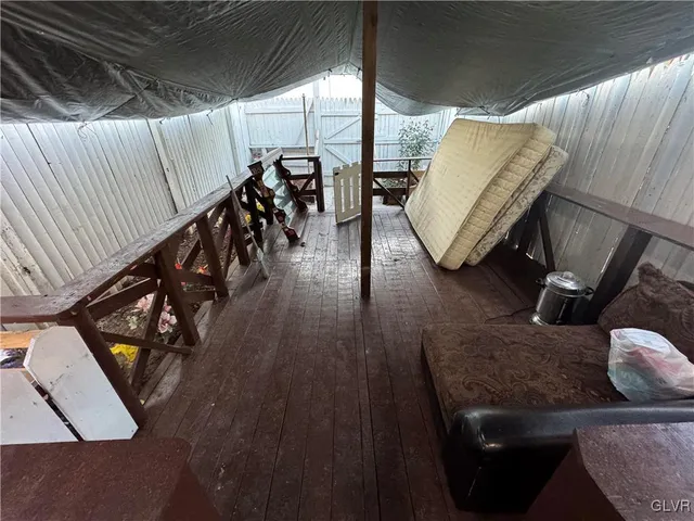 a living room with wooden floor and furniture