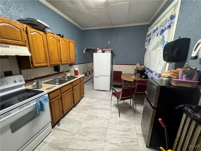 a kitchen with a sink cabinets and black appliances