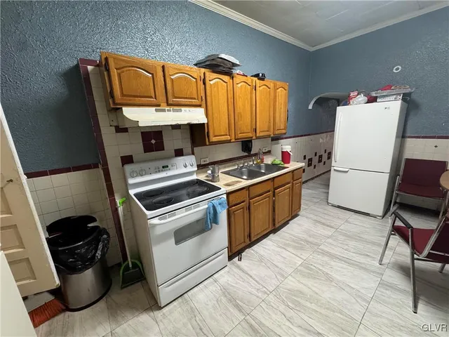 a kitchen with a stove a sink and a refrigerator