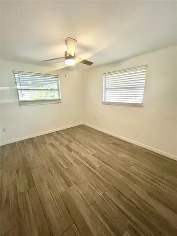 a view of a room with wooden floor