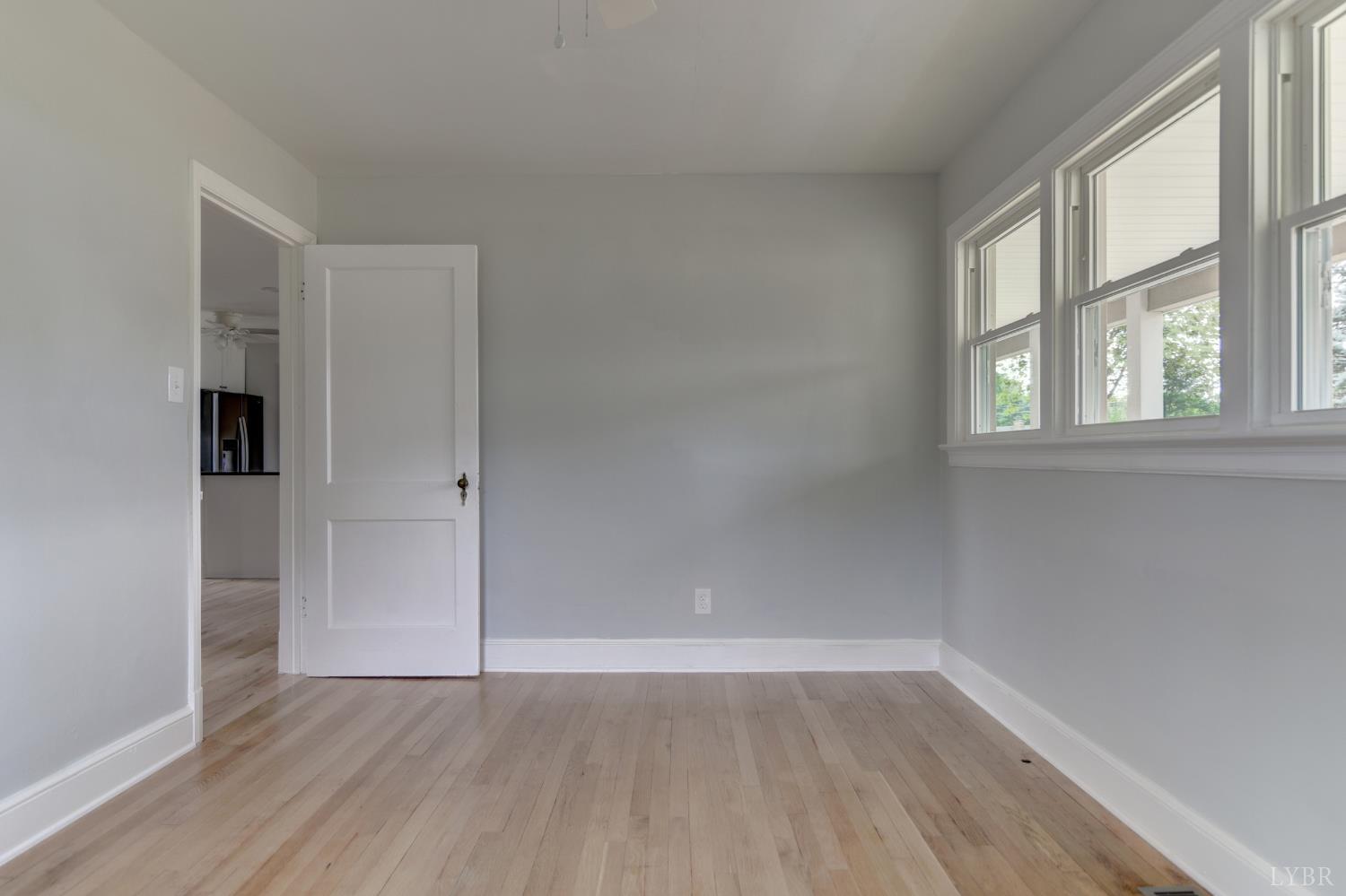 4724 Old Boonsboro Road Lynchburg, VA 24503 - Photo 16 of 39 an empty room with wooden floor and windows
